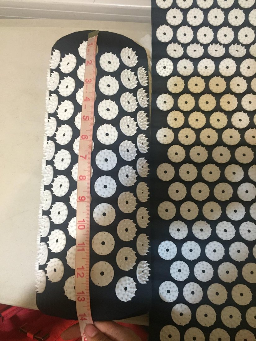 Customer photo showing the acupressure mat measured with a tape measure